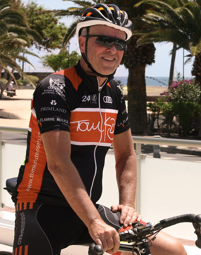 Laurent sat on his bike smiling and looking relaxed